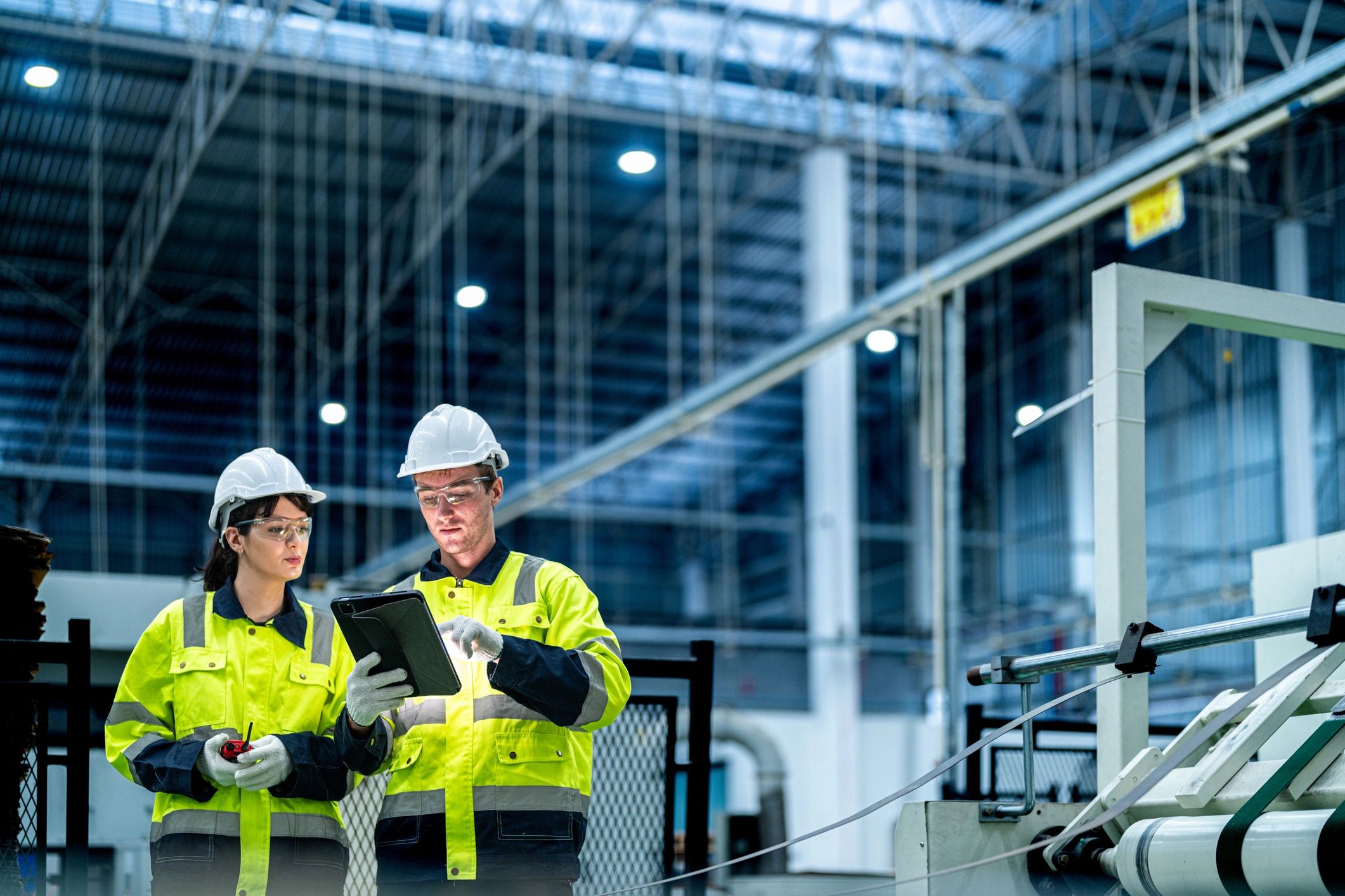 Fabrication manager overseeing metalwork in a factory.